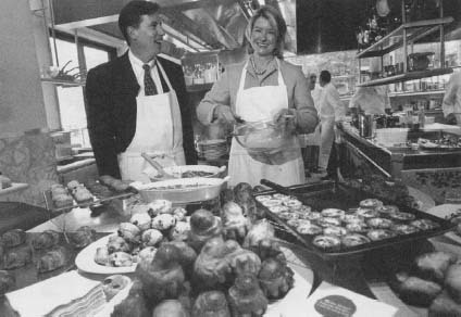 Former Kmart CEO Chuck Conaway talks with Martha Stewart at the October 2000 debut of Martha Stewart Everyday Kitchen, an extensive line of housewares available only at Kmart. Reproduced by permission of AP/Wide World Photos.